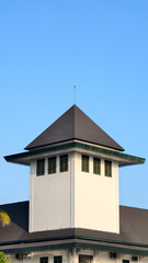Obraz premium Traditional Corner Tower With Pyramid Roof and Louvered Windows