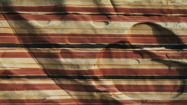 Layered red sandstone rock texture. Natural geological background