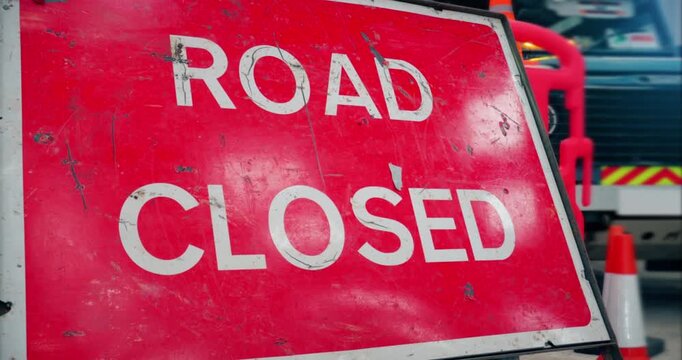 Road closed street sign &ndash; Emergency services diverted traffic highway road sign in the event of a roadblock. Travel closed on street. Red signage marking temporary closure at incident or crime scene.