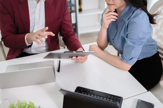 Financial admin reviewing data at worktable in professional office