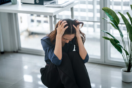 Tired asian businesswoman overworking&nbsp;and headache stressed in office