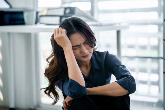 Tired asian businesswoman overworking&nbsp;and headache stressed in office