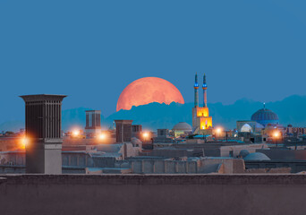 Historic City of Yazd with famous wind towers in the background full moon at twilight blue hour- YAZD, IRAN  © muratart