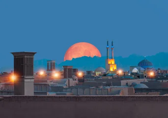 Historic City of Yazd with famous wind towers in the background full moon at twilight blue hour- YAZD, IRAN  © muratart