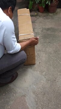 Flipping Cardboard Box to Remove Plastic Cable Ties