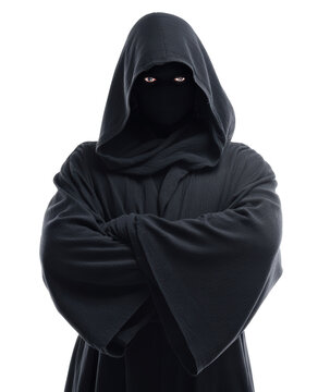 Anonymous hooded figure with covered face and crossed arms.