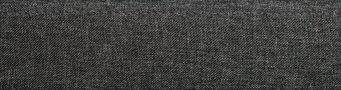 Dark grey textured upholstery fabric surface with detailed woven canvas material pattern