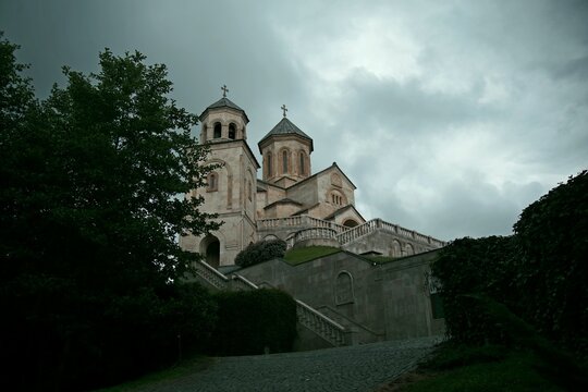 Ancient Bodbe monastery under dramatic storm sky in Georgia with copy space