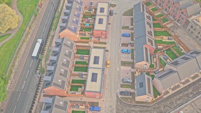 New residential development beside A1018 Burdon Road in Riverside Sunderland, Sunderland, Tyne and Wear, England, featuring modern townhouses and landscaped streets, drone lateral slide.