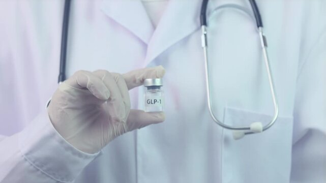 Professional doctor in glove holding GLP1 vial for medical weight management treatment offers caring guidance with stethoscope