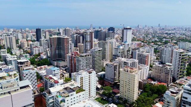 Urban Skyline And High-Rise Buildings Of Santo Domingo On The Caribbean Sea Coast In The Dominican Republic. aerial sideways shot