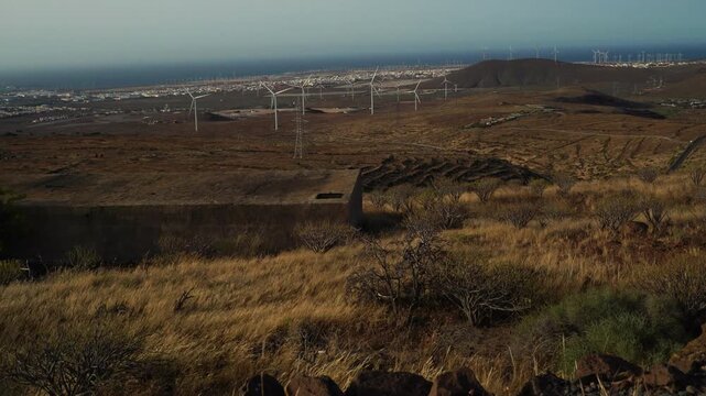 Revealing shot of the impressive farm of windmills on the coast of Gran Canaria