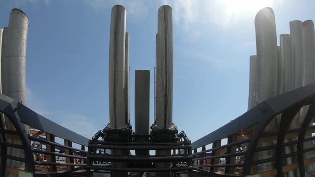 Close view of cruise ship exhaust funnels with dark soot streaks and oily residue on the outer surfaces