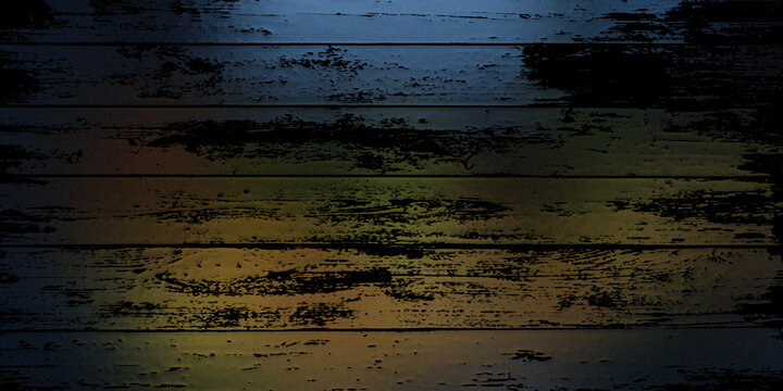 Grunge wooden planks background with dark shadows and colorful light leaks across boards.