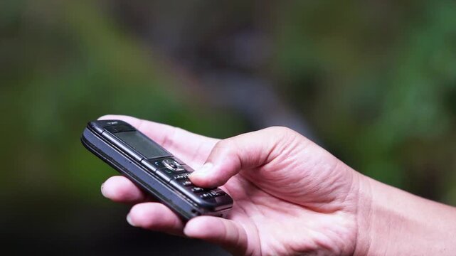 Using a mobile phone in the 2000s. One type of vintage mobile phone.