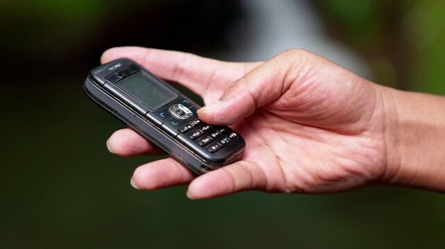 Using a mobile phone in the 2000s. One type of vintage mobile phone.