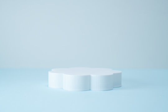 Minimalist Flower-Shaped Product Display Podium on Light Blue Background