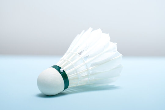 Close-up of a Badminton Shuttlecock Resting on Light Blue Background