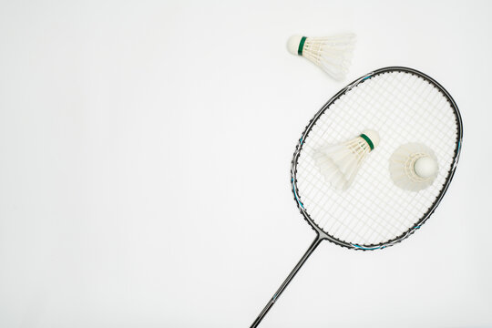 Top View of a Single Badminton Racket and Shuttlecocks on White Background