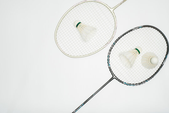 Two Badminton Rackets and Shuttlecocks Arranged on a White Background