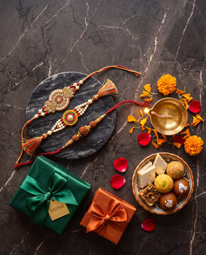 Luxury flat lay composition featuring handcrafted rakhis, gift boxes, and traditional sweets for Raksha Bandhan, elegant Indian festival aesthetic, sibling bond, Raksha Bandhan 2026