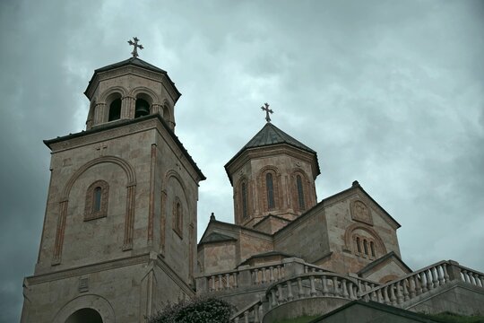 Historical Bodbe monastery complex under dramatic storm sky in Georgia with copy space
