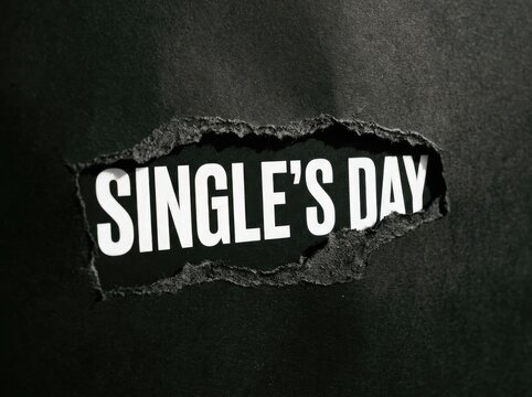 Torn Black Paper Revealing 'Single's Day' Text, Consumerism Concept