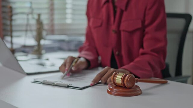 Female judge signing legal documents in courtroom