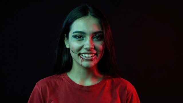 Creepy smiling woman with blood effect halloween horror portrait