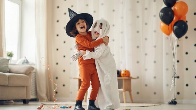 Halloween fun two young children in costume embrace joyfully