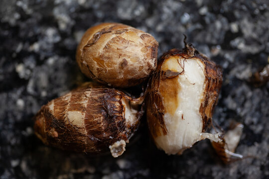 Boiled taro roots on black marble countertop