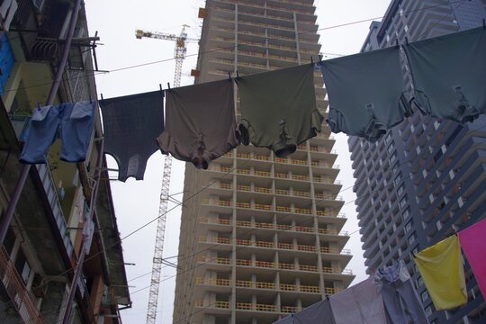  Urban contrast in Batumi with colorful laundry drying against building construction
