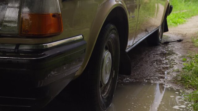 Close-up of water dripping from a freshly washed classic car after cleaning. Ideal for car care, auto detailing, vehicle washing and restoration content.