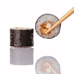 Two fresh sushi maki rolls with chopsticks © Cavan