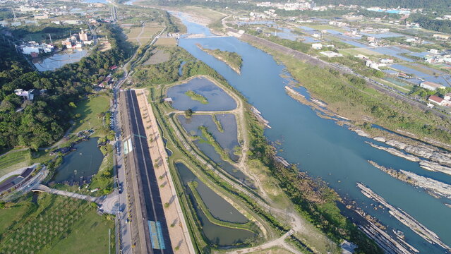 Aerial view of a scenic riverside park and wetlands.