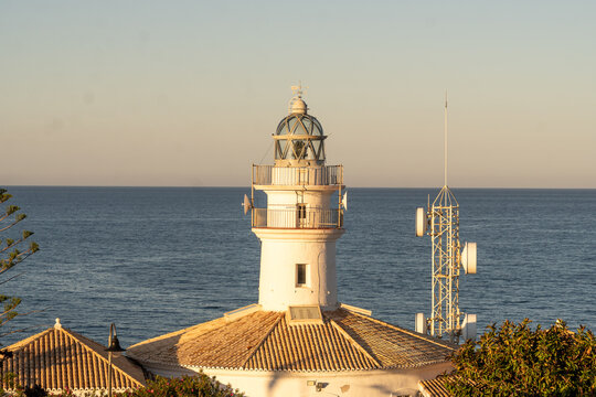 Mediterranean landscapes. Cullera lighthouse with the calm sea in the background
