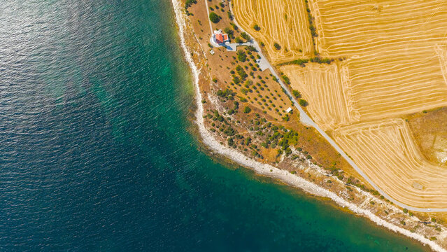 Seddulbahir, Eceabat, Turkey. Aerial view of historic Mehmetcik Feneri lighthouse at Cape Helles on Gallipoli Peninsula with Dardanelles Strait and Aegean Sea. Clear sunny day. Aerial view.