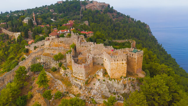 Alanya, Turkey. Drone shot of the strategic Ehmedek Castle showing its three towers and water cisterns, built to protect Alanya Fortress from land.. Aerial View