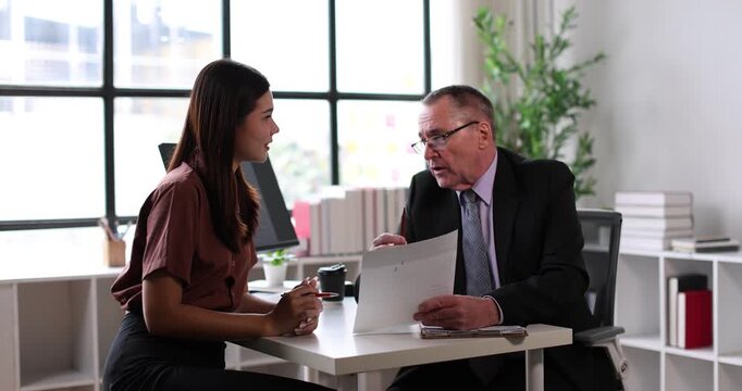 Young businesswoman attending a job interview, holding a document while a male recruiter reviews applicants on a clipboard, signifying human resources, career planning, and new employment