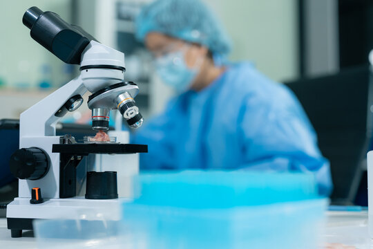 Lab work, Scientist analyzing biological sample for virus detection in modern laboratory.