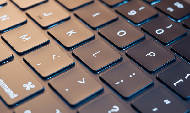 Keyboard computer close up, backlit keyboard background