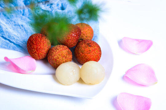 Whole And Peeled Fresh Lychee Fruits On Dark Wooden Tray