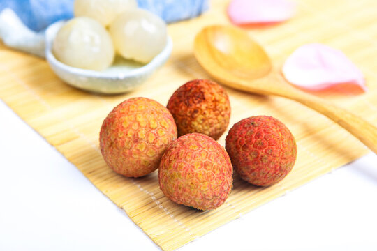 Whole And Peeled Fresh Lychee Fruits On Dark Wooden Tray