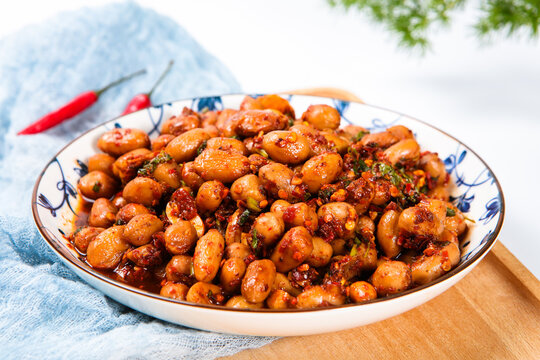 Spicy Marinated Peanuts With Chili And Herb On Porcelain Plate