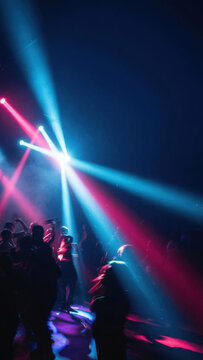 Concert Crowd Silhouette under Blue and Red Stage Light Beams