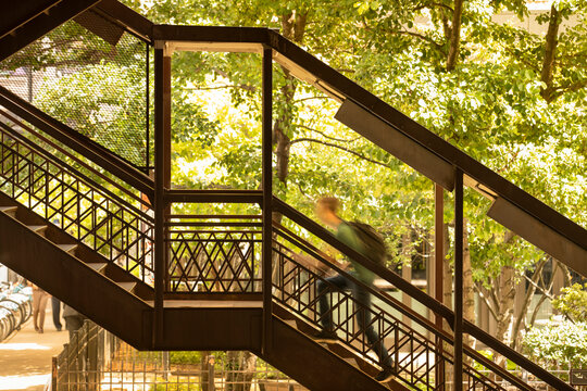 A man walks up the stairs to the elevated train in Chicago