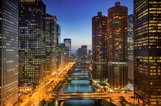 High angle view of Chicago River and illuminated skyline at twilight
