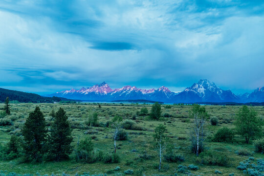 Mountain range beneath dramatic morning clouds.