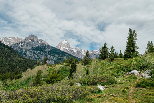 Mountain landscape beneath textured clouds on a summer day.