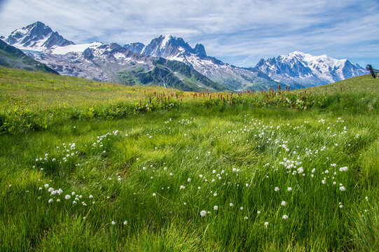 Scenic view of mountains and small cabins in a green valley during a